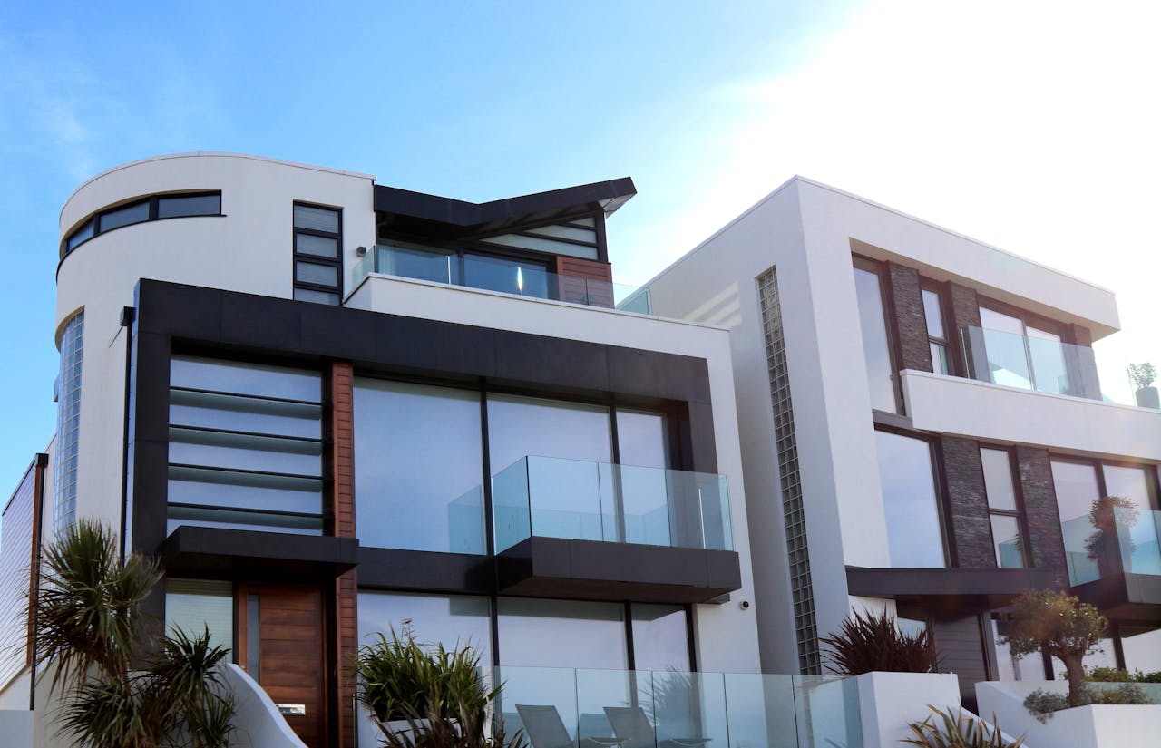 ours-journey Contemporary luxury home with glass balconies in Poole, UK, showcasing modern architectural design.